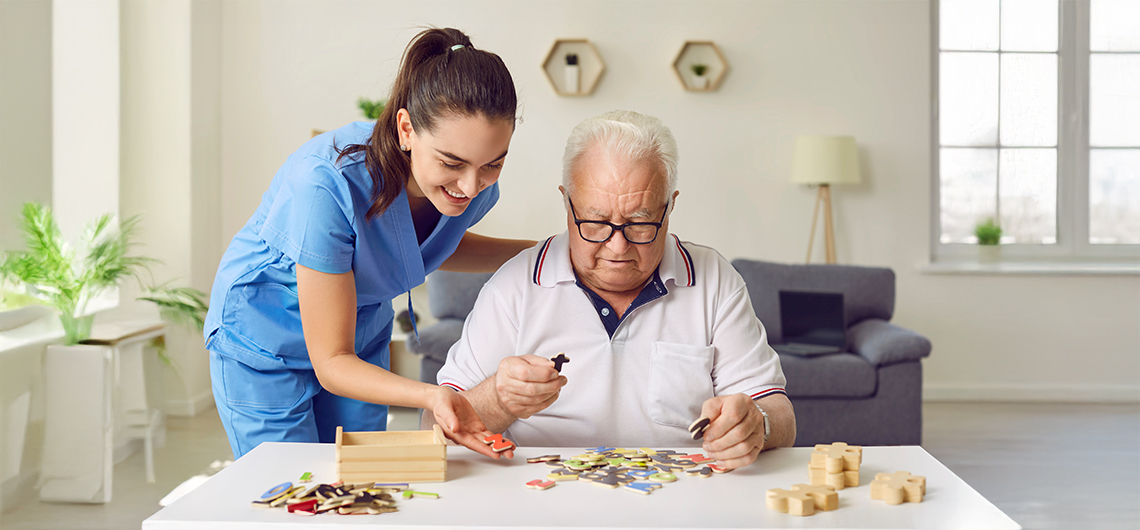 Nurse is helping Alzheimer/Dementia senior patient with puzzle activity