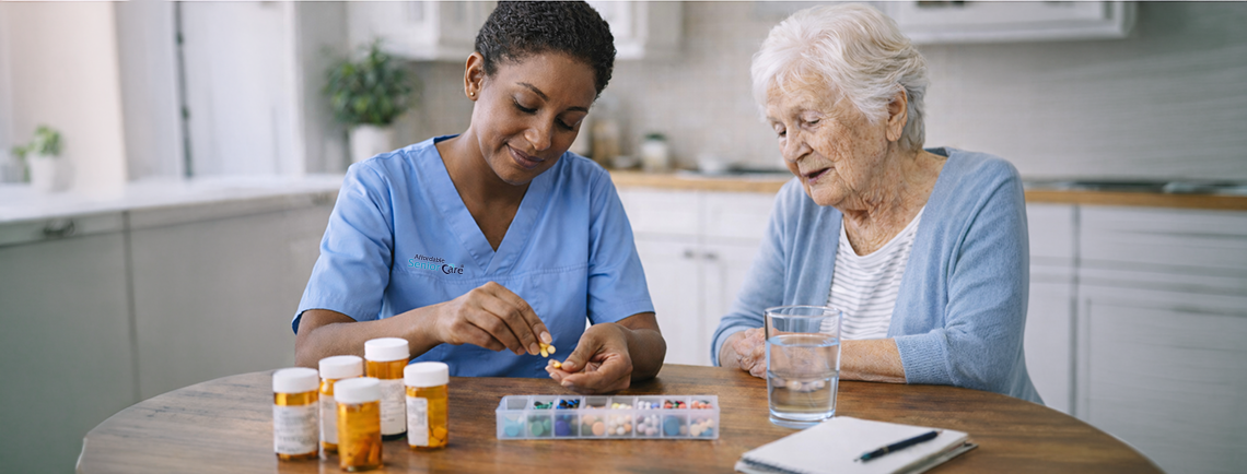 Affordable Senior Care Aide sorting medication for her elderly patient